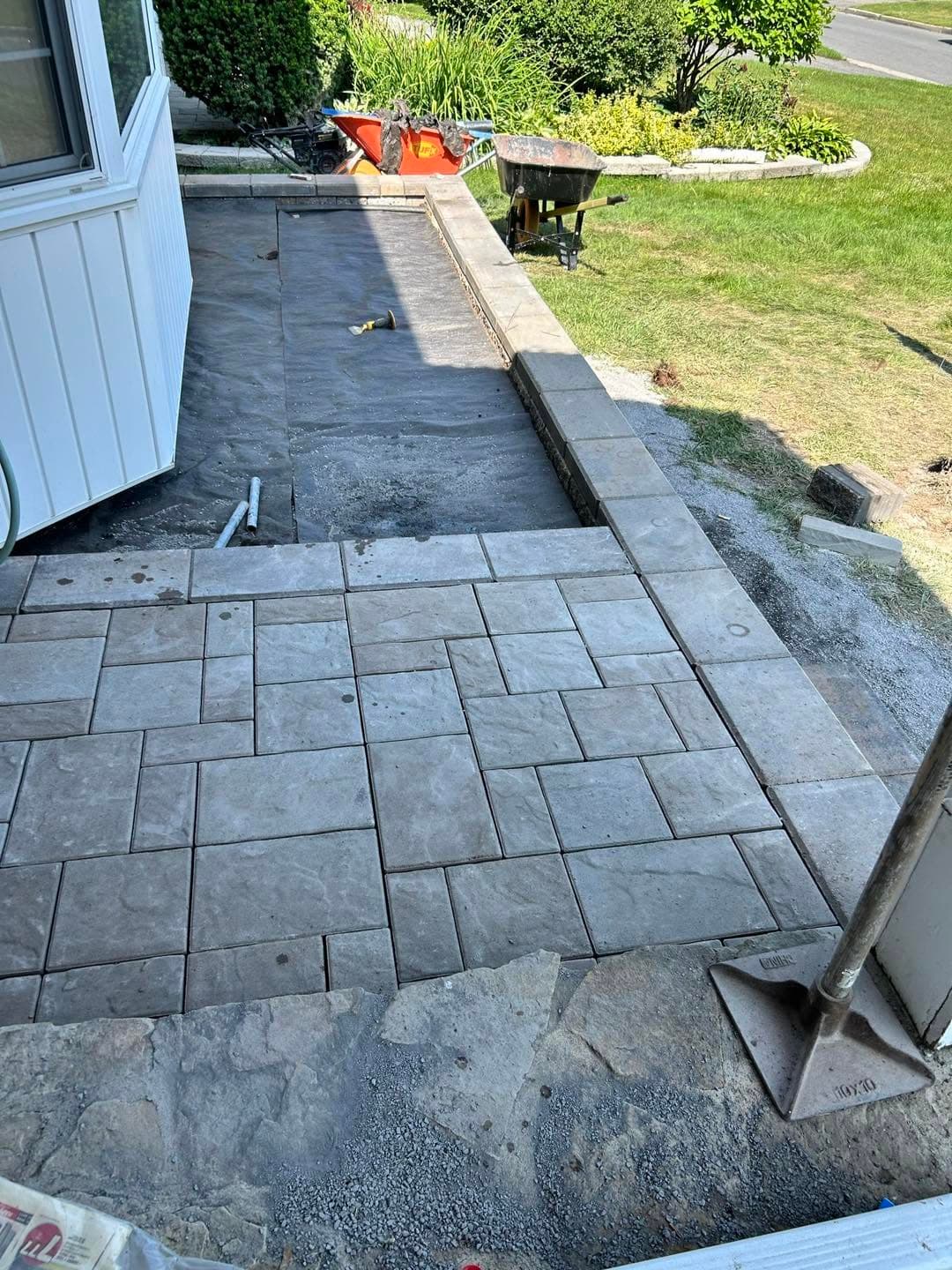 Slab patio and retaining wall mid-installation