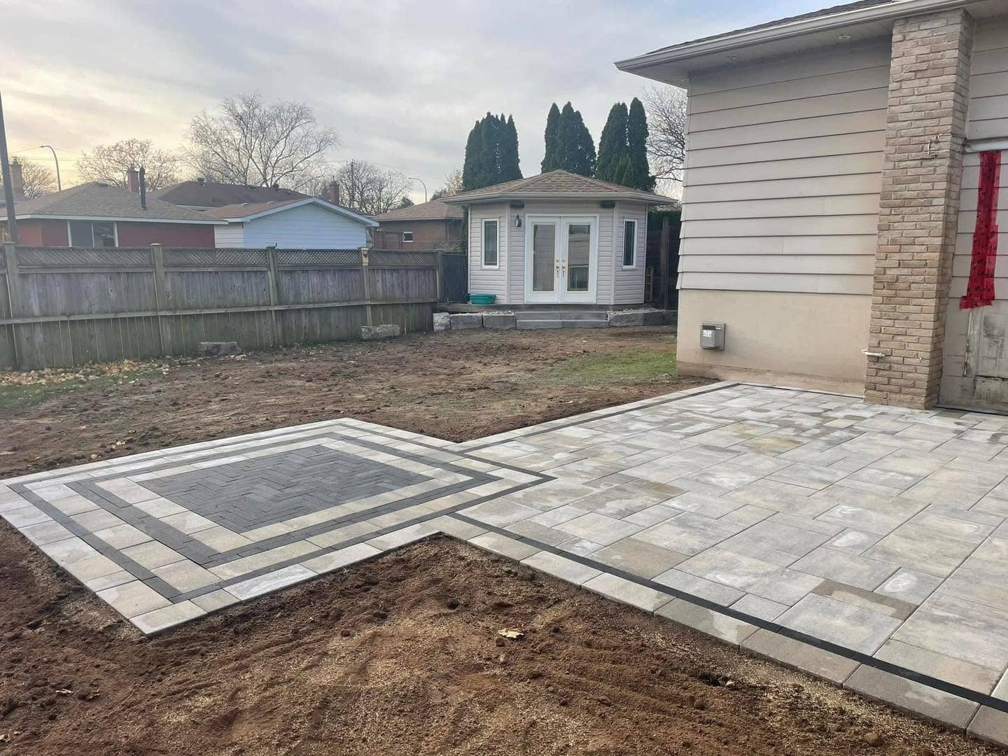 Two-tone interlock patio with inlaid border, built by BHOSS in Eastern Ontario