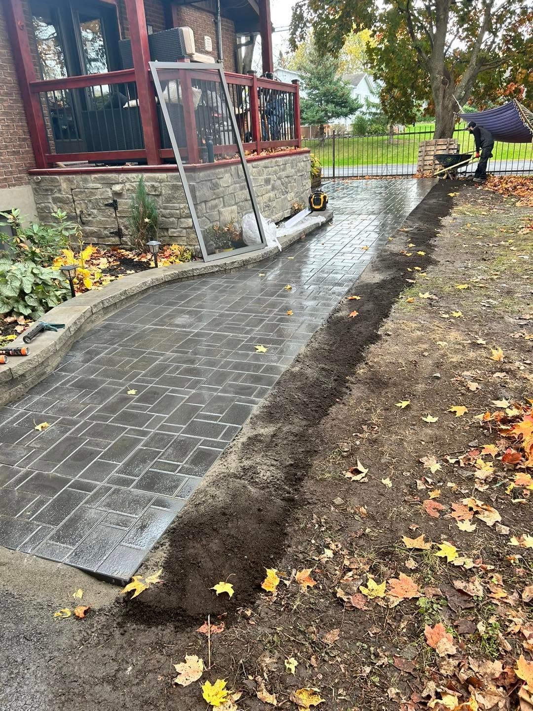 Curved interlock walkway installed beside a front porch